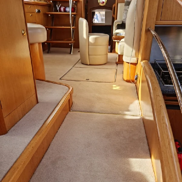 Beige cut pile marine carpet installed throughout a luxury yacht interior.