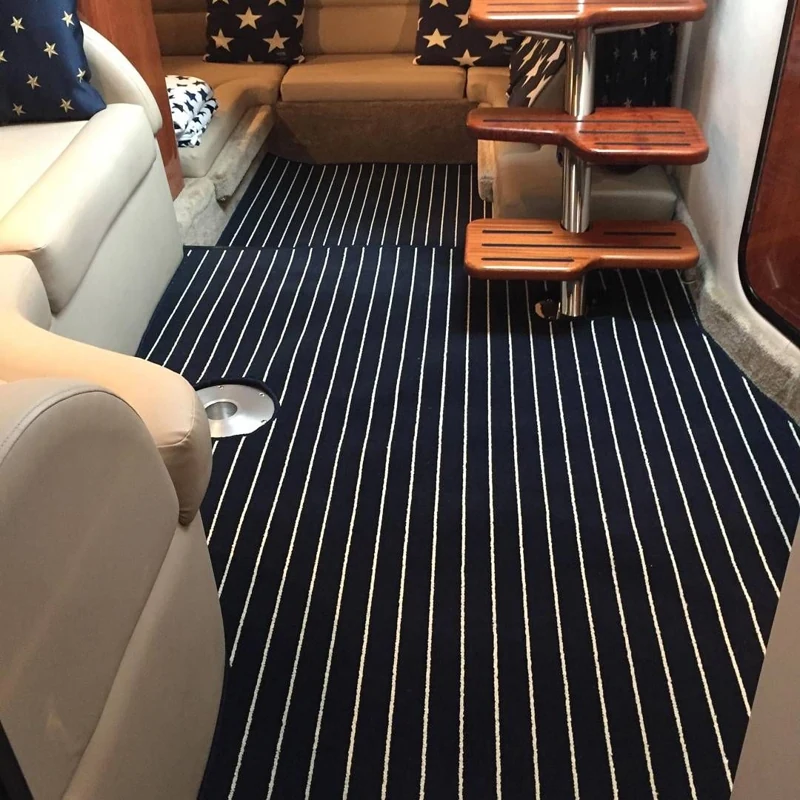Navy blue boat flooring with white stripes in a cabin