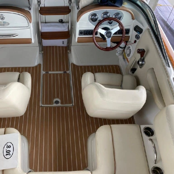 Tan and white striped teak-style marine carpet in a boat cockpit.